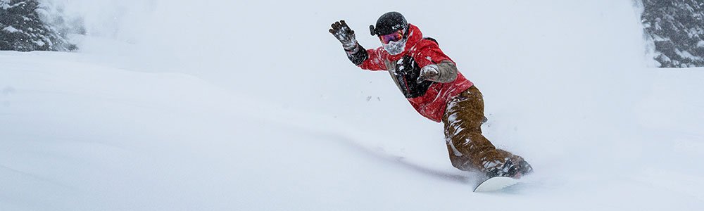 Family enjoying Idaho's ski resort with options for skiing, snowboarding, and gear rentals, including lift passes, trail maps, and scenic access to a vibrant terrain park.